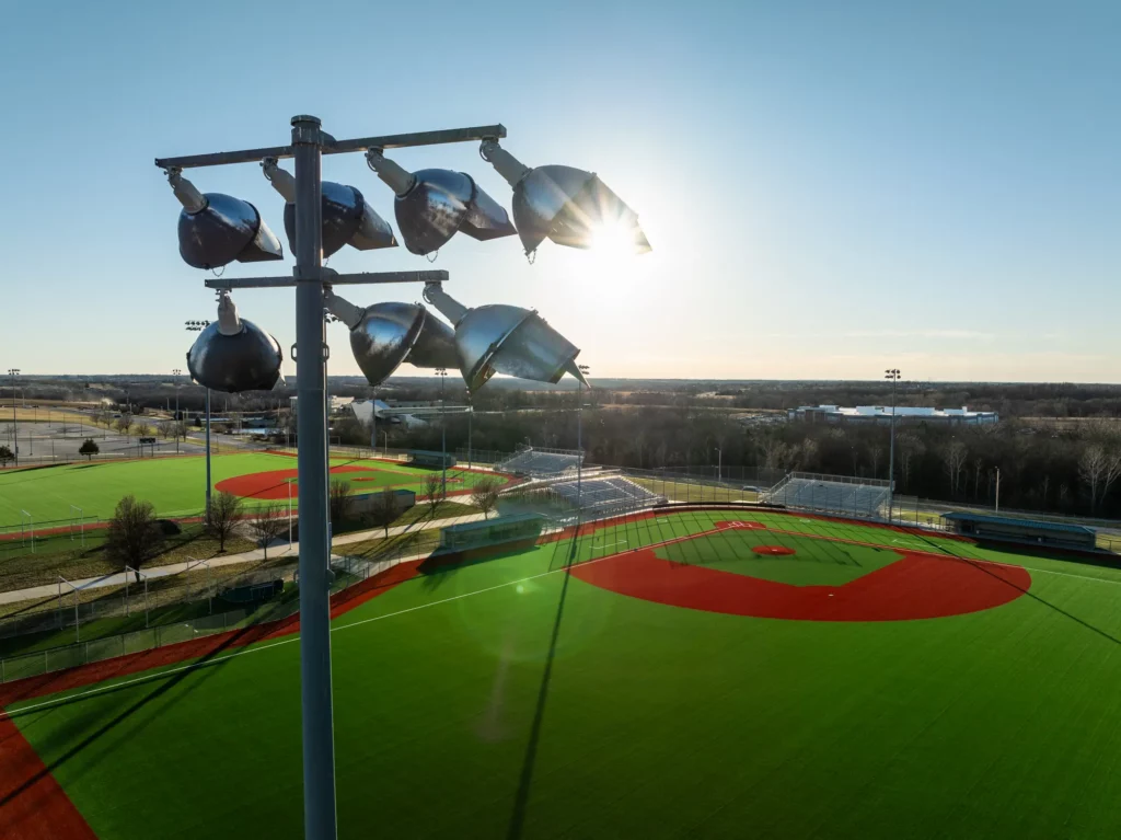 Stadium light pole over an Olathe Public Schools synthetic turf baseball field