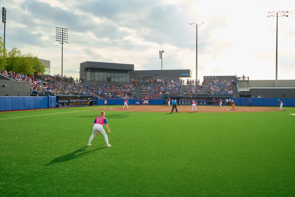 Player on the synthetic turf softball field at University of Kansas Arrocha Ballpark