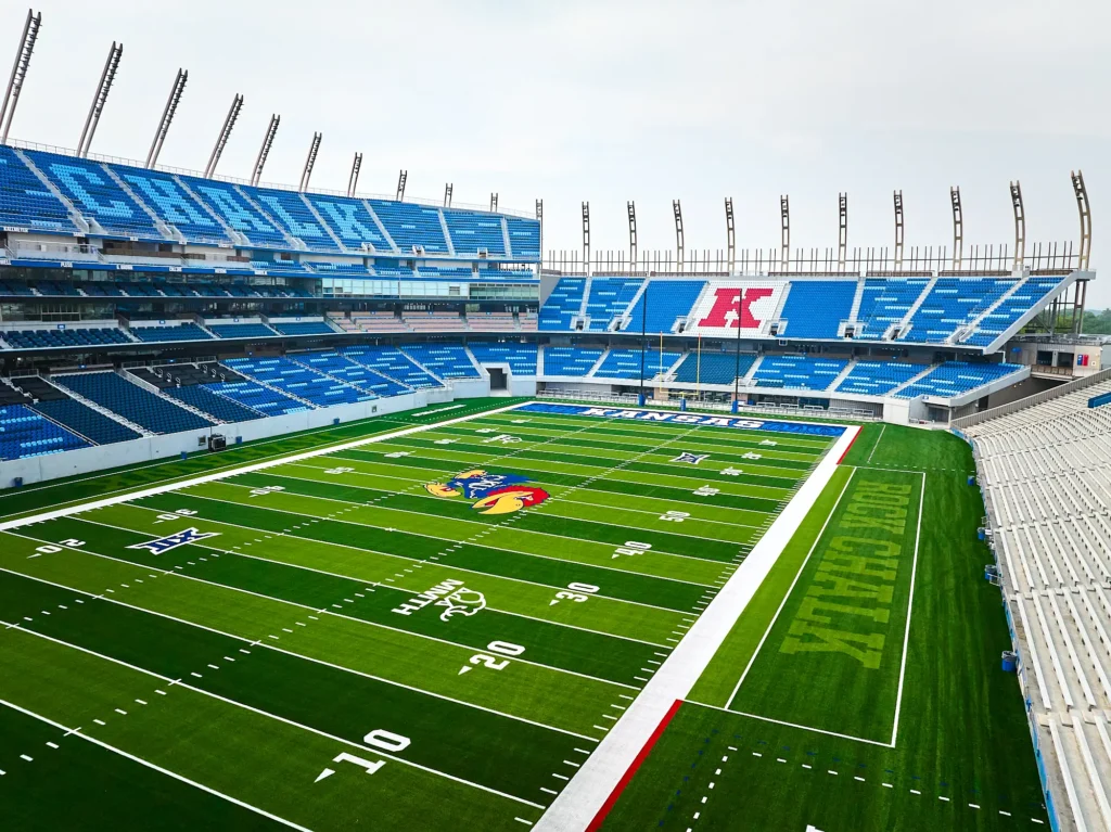 Aerial view of the new synthetic turf football field and K logo seating at University of Kansas David Booth Kansas Memorial Stadium